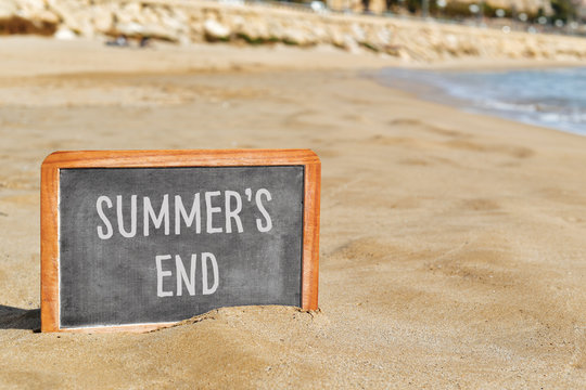 text summers end in a chalkboard on the beach