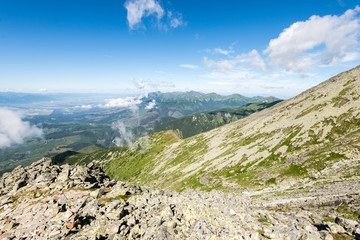 Obraz premium rocky mountain landscape covered with clouds