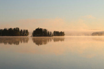 Fototapeta premium Sunrise on the lake with haze.
