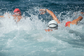 Group of swimmers in the sea right after the start