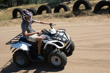 Man or young boy is driving a quad