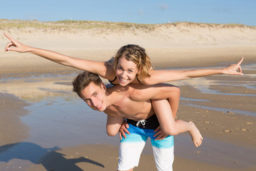 Piggy Back Fun on the beach. Honey Moon