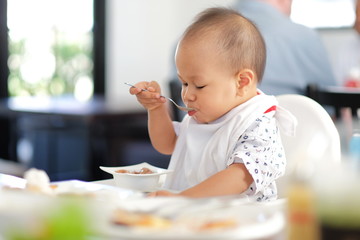 baby boy eating ice cream and Playing smartphone.