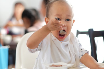 baby boy eating ice cream and Playing smartphone.