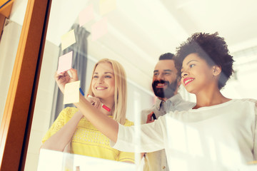 Fototapeta premium happy creative team writing on stickers at office