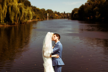 Passionate kiss on the bank of the lake