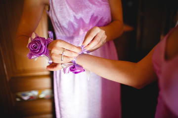 Wedding boutonnieres on the hands of bridesmaids