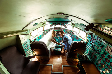 Crazy couple inside the cabin of an old plane