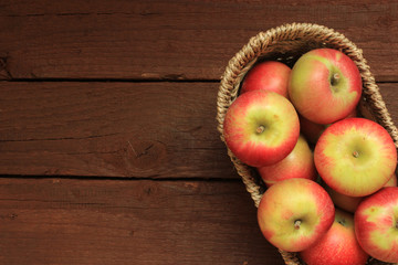 Apples in a basket on wooden background