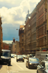 Cars driving on the street in the summer Riga. Blurry