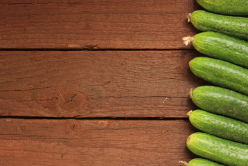Cucumbers on wooden background