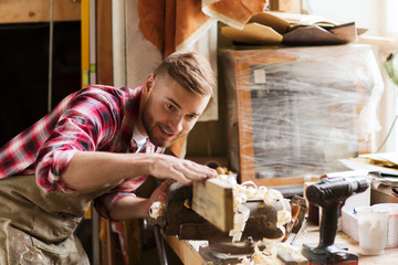 carpenter working with wood plank at workshop