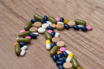 arrow made of tablets on wooden table