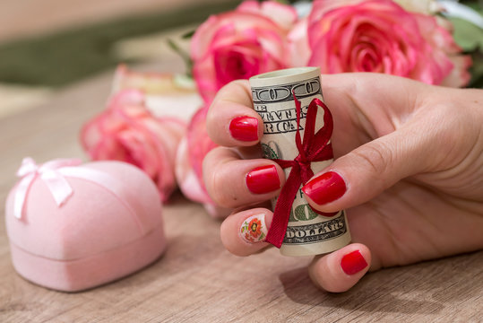 pink box, roses, money on the table