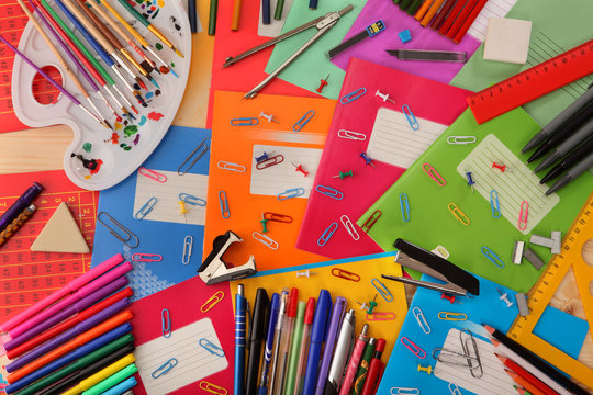 Background of school notebooks, pencils, pens, staplers, rulers and other school supplies.