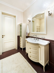 Interior of toilet room with a washbasin, a mirror and a towel
