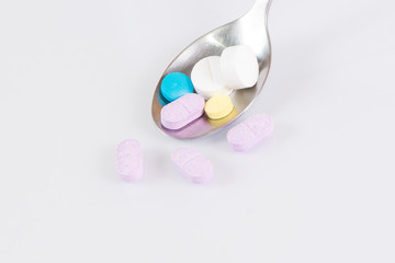 The medicines and spoon  isolated on a white background, clipping path 
