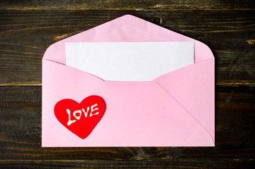 Pink envelope and blank white card 