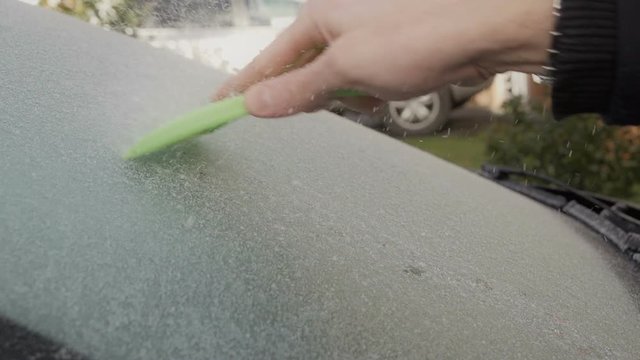 De-icing A Car Windscreen After Jack Frost Has Been. Filmed In Super Slow Motion
