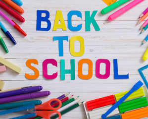 Back to school composition on white wooden background