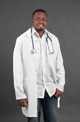 Professional African doctor on dark background