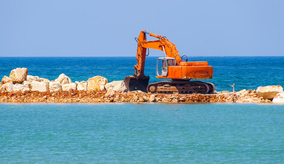 building the jetty with heavy excavator machine..Note the turbulence of the air emitted from the exhaust pipe of the excavator