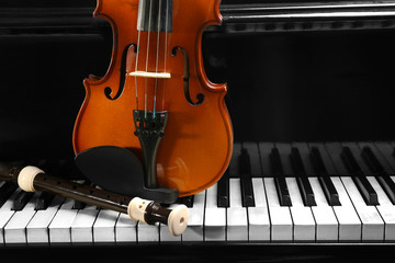Flute and violin on piano keys