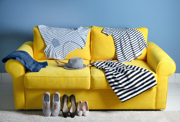 Family clothes on the yellow sofa