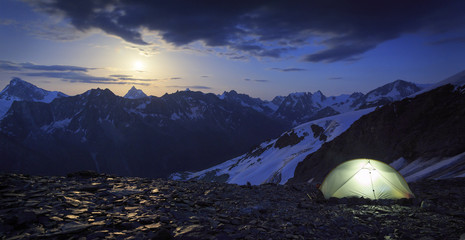 High altitude campesite with the moon rising above the Matterhorn in Wallis, Switzerland. Outdoor...