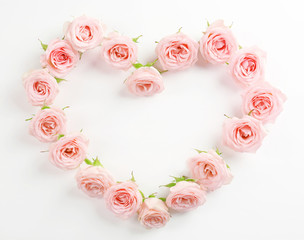 Fototapeta na wymiar Heart shaped roses on white background
