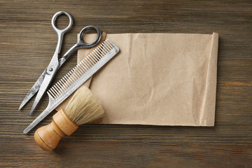 Vintage tools of barber shop on wooden background