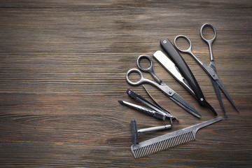 Vintage tools of barber shop on wooden background