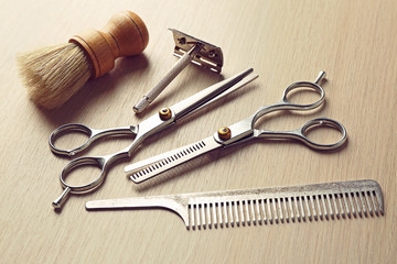 Vintage tools of barber shop on wooden background