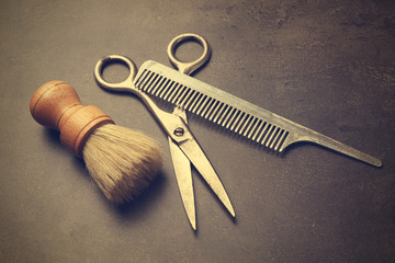 Vintage tools of barber shop on grey background