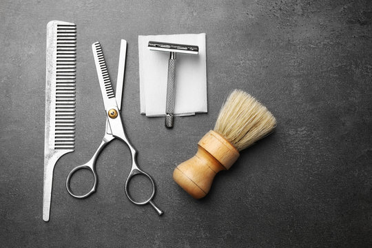 Vintage tools of barber shop on grey background
