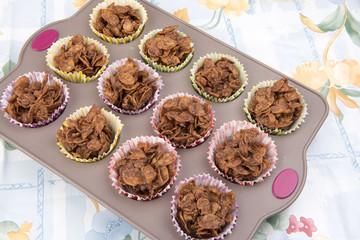 Close up image of homemade chocolate cereal cakes in a baking tray 