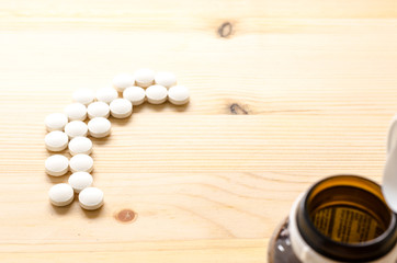 medicine tablets on wood background