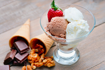 Ice cream sundae, chocolate, walnuts and strawberry 