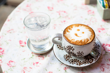 cup of cappuccino on table.