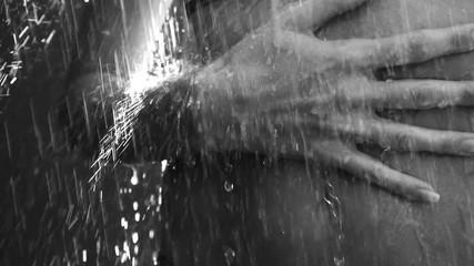 Closeup of woman stomach with touching hands under outdoor shower - black and white video