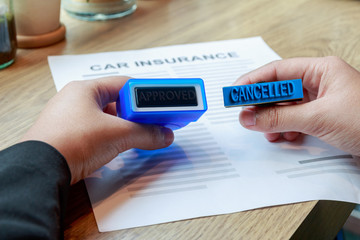 Businesswoman holding approved and cancelled rubber stamp