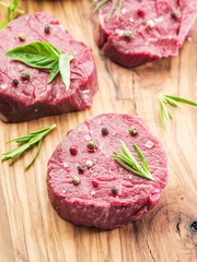 Pieces of beef tenderloin on the wooden cutting board.