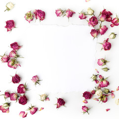 Frame with dried pink roses. Top view. Flat lay.