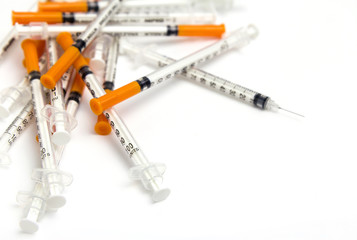 Pile of medical syringe isolated on white background