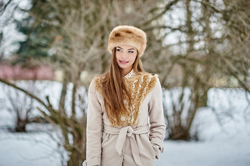Portrait of a beautiful girl in winter forest