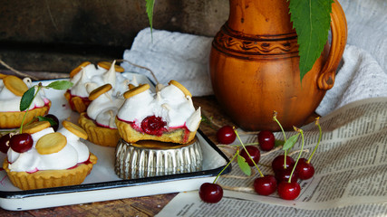 pastry tartlets with meringue and cherry