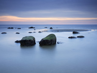 Fototapeta na wymiar Coastal Sunset, Beach with Huge Boulders, Rugen Island, Germany