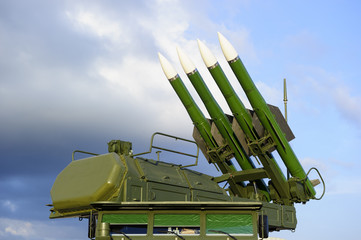 Missile launcher with four ballistic missiles ready to attack and radar on top of army...