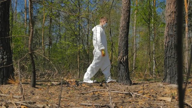 Young manin special suit walking in the wood