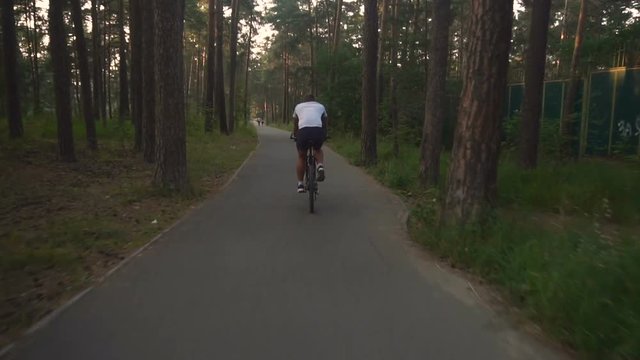 Cyclist rides in the park slow motion